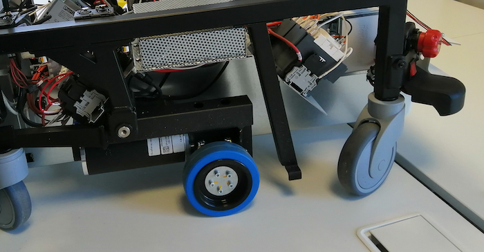 Plastic fenders are identified around the perimeter of the mobile robot to enclose and protect the internals. These are prone to crack under heavy mechanical stress.