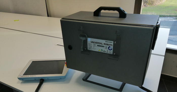 Universal Robots UR3 robot CB3.1 controller and teach pendant (HMI). Controller has a mechanical lock to secure physical access.