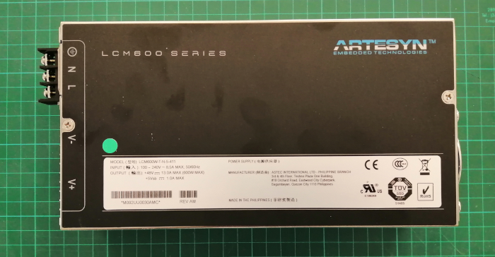 The PSU is a Artesyn LCM600 series with an output of 48 V, and an input of 85–264 Vac. Has a typical full load efficiency of 89% up to 600 watts. 