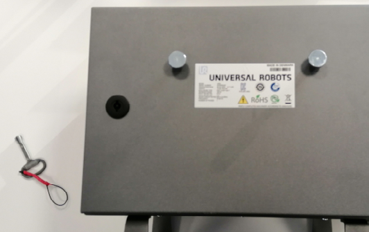 A) Universal Robots UR3e controller. The controller has a mechanical lock aimed to prevent ingress to the internals from non-authorized parties.