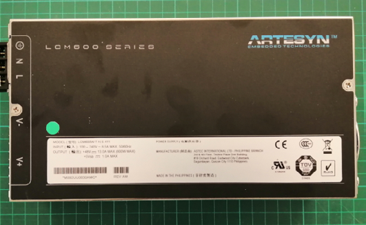 E) The PSU is a Artesyn LCM600 series with an output of 48 V, and an input of 85–264 Vac. Has a typical full load efficiency of 89% up to 600 watts.
